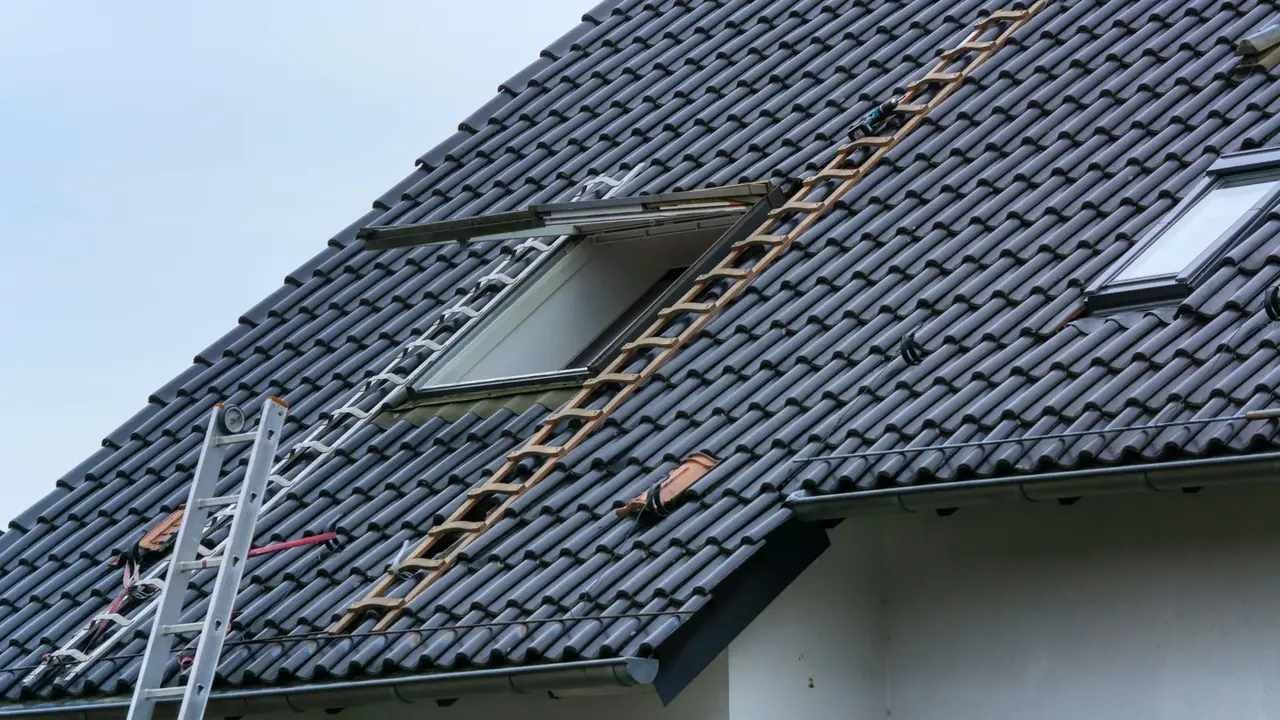 Remedial work on a tiled roof with ladders in place