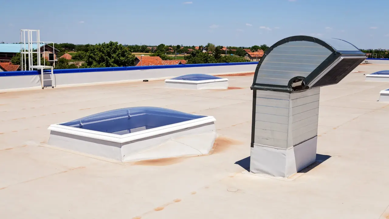 Renewed single-ply flat roof with rooflights