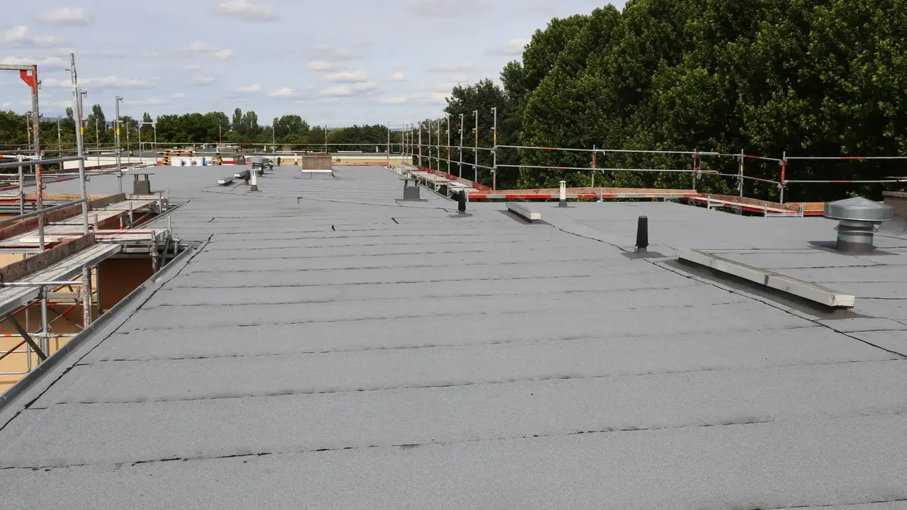 Flat roof with a new membrane and roof vents