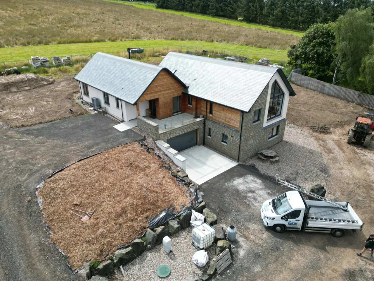 Completed slate roof on a new house with the Ericht Roofing van on site